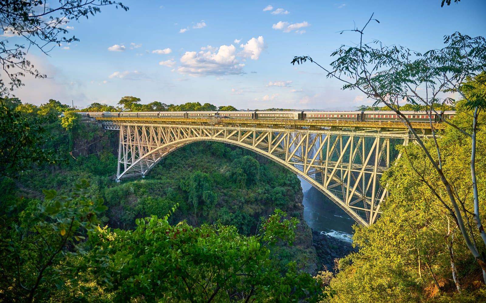 Der Rovos Rail überquert die Victoria-Falls-Brücke über der grünen Schlucht des Sambesi